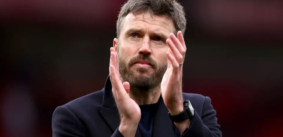 Man applauding on the sidelines during a match