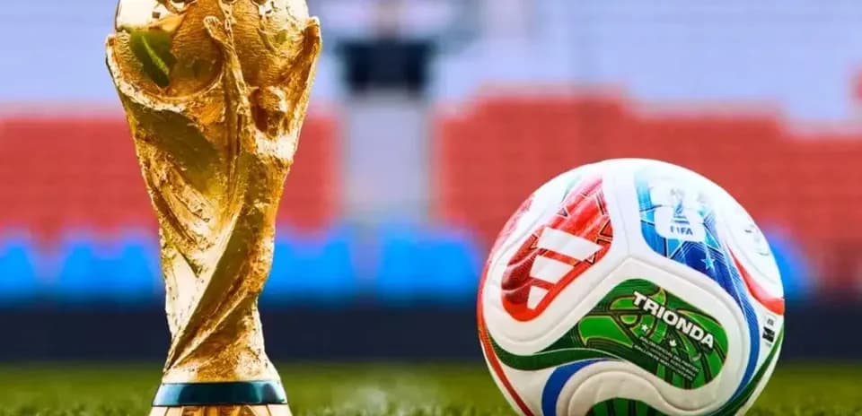 FIFA World Cup trophy next to a football