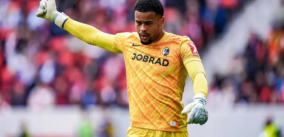 Goalkeeper gesturing during a match in yellow kit