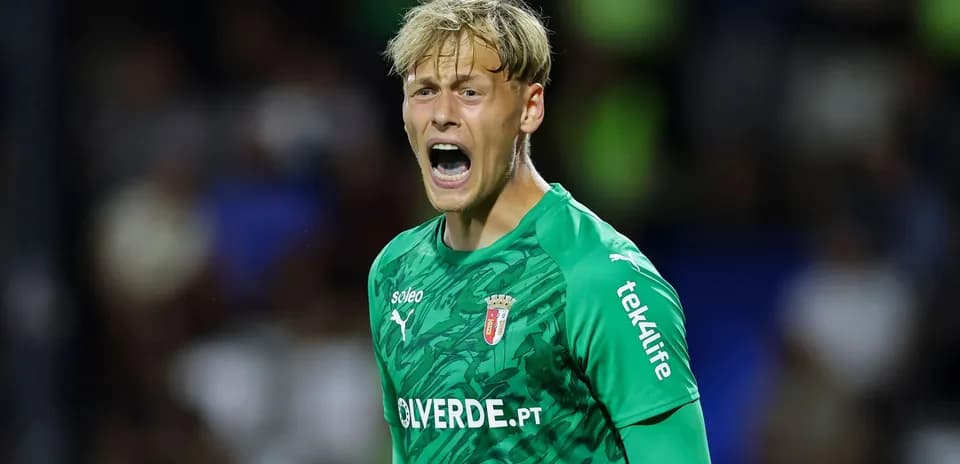 Goalkeeper yelling during a match in green kit