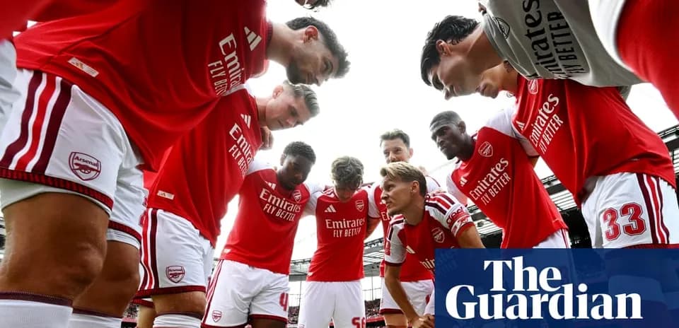 Arsenal players huddled before a match