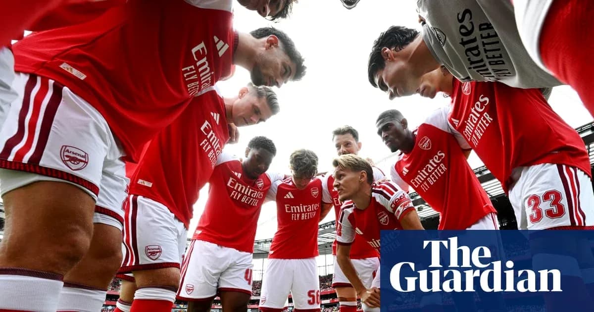 Arsenal players huddled before a match