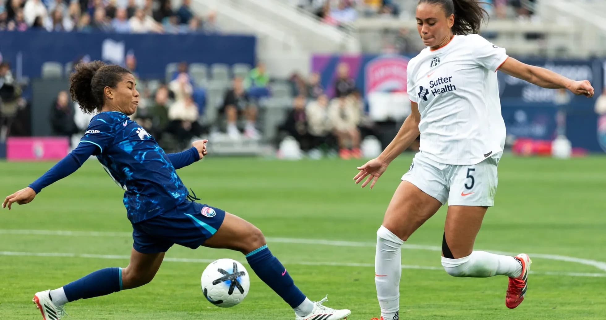 Players competing for the ball in NWSL match