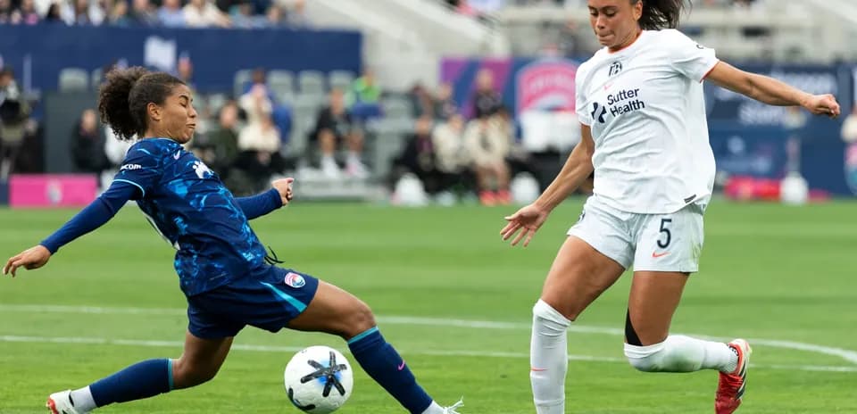 Players competing for the ball in NWSL match
