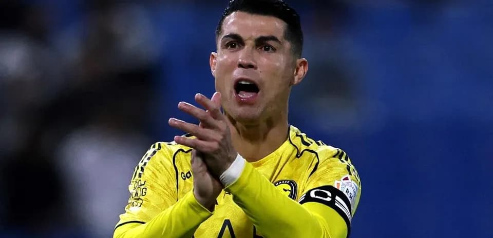 Player in yellow jersey clapping during match