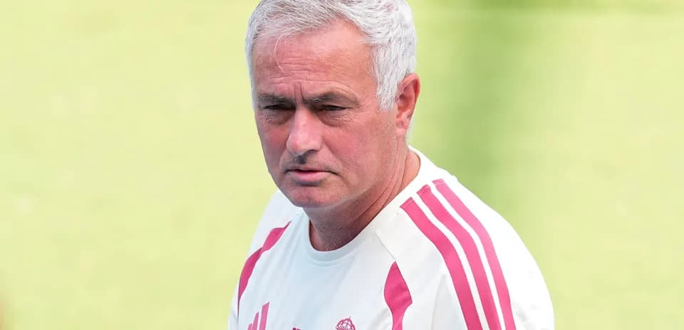 Coach observing training session on the pitch