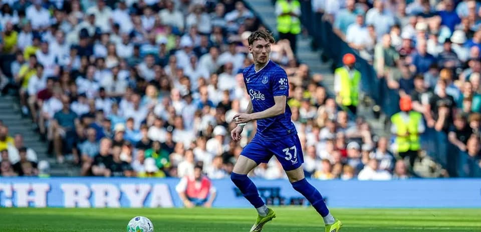 Player in blue kit running with the ball during match