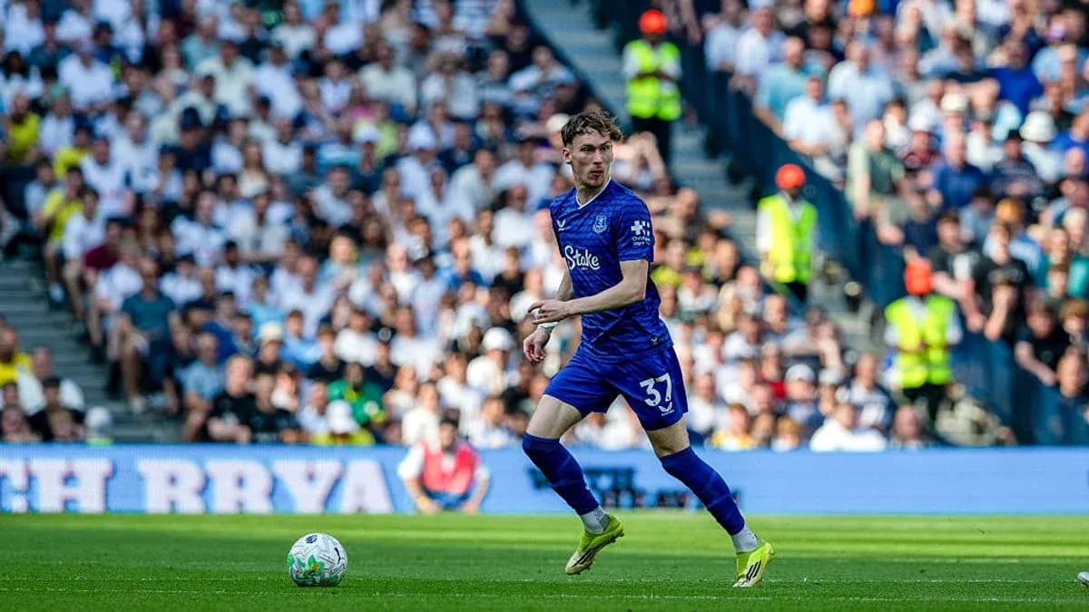 Player in blue kit running with the ball during match