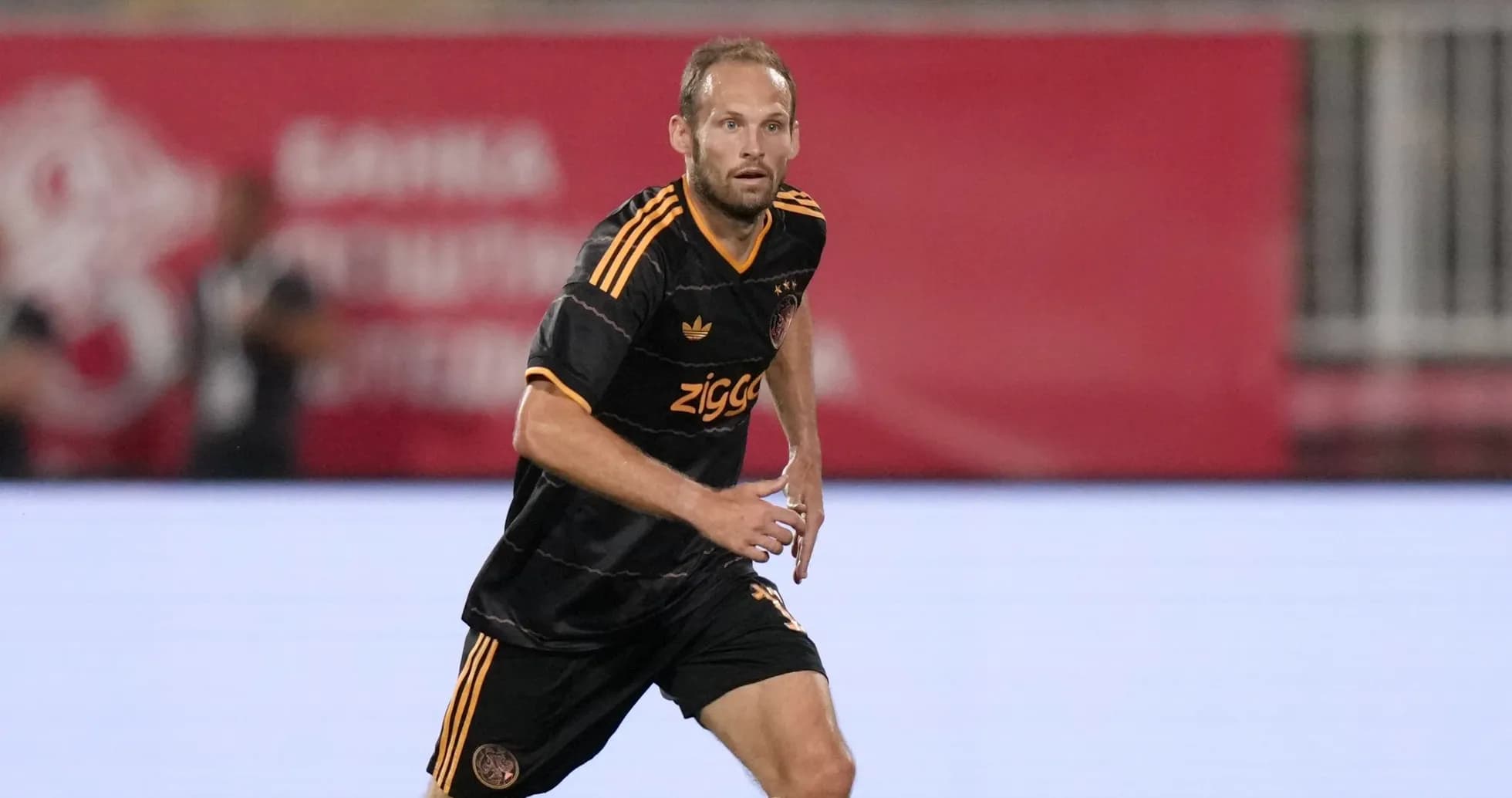 Player in Ajax kit running on the field