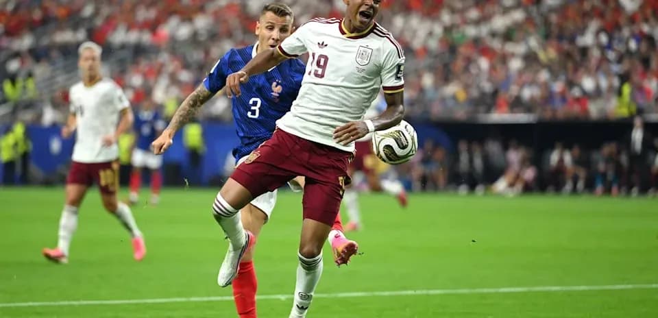 Player from Spain being challenged by French defender