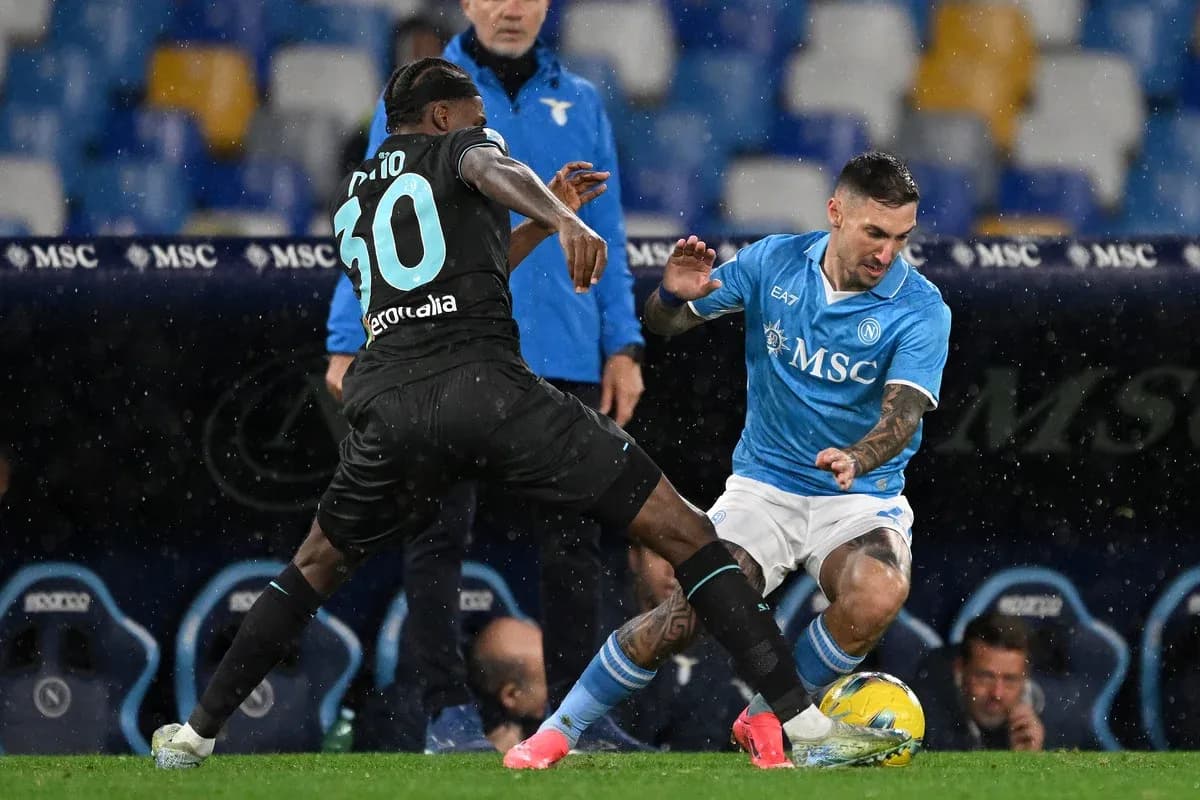 Napoli player challenging Lazio opponent for the ball
