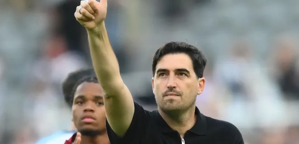 Coach giving thumbs up gesture on the field