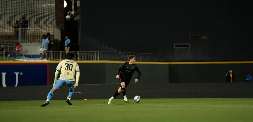 Player dribbling the ball in USL match
