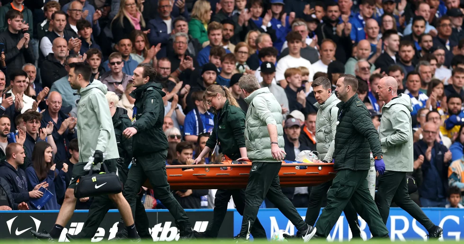 Medical team carrying stretcher off the field