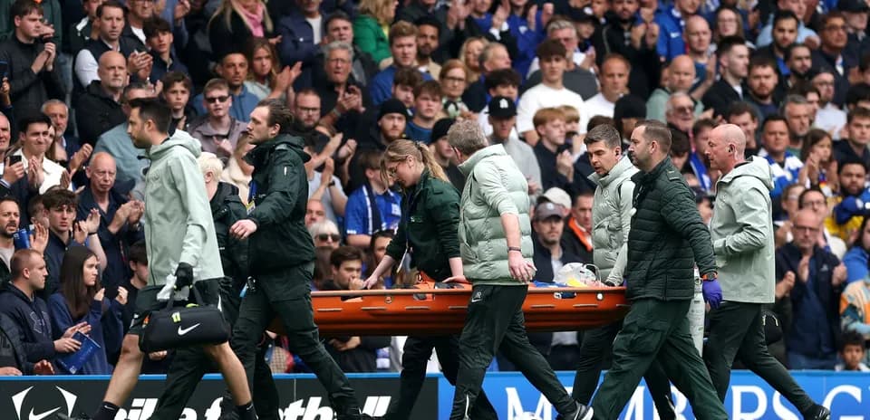 Medical team carrying stretcher off the field