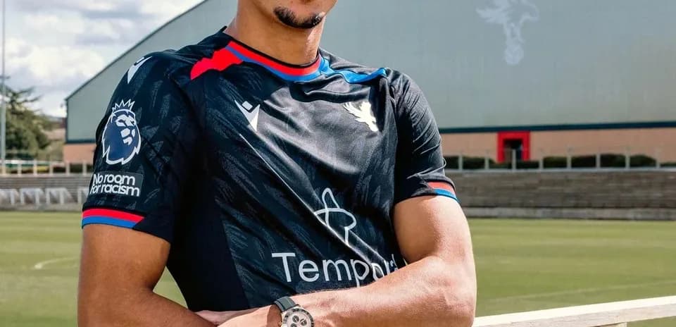 Player posing in Crystal Palace training kit outdoors