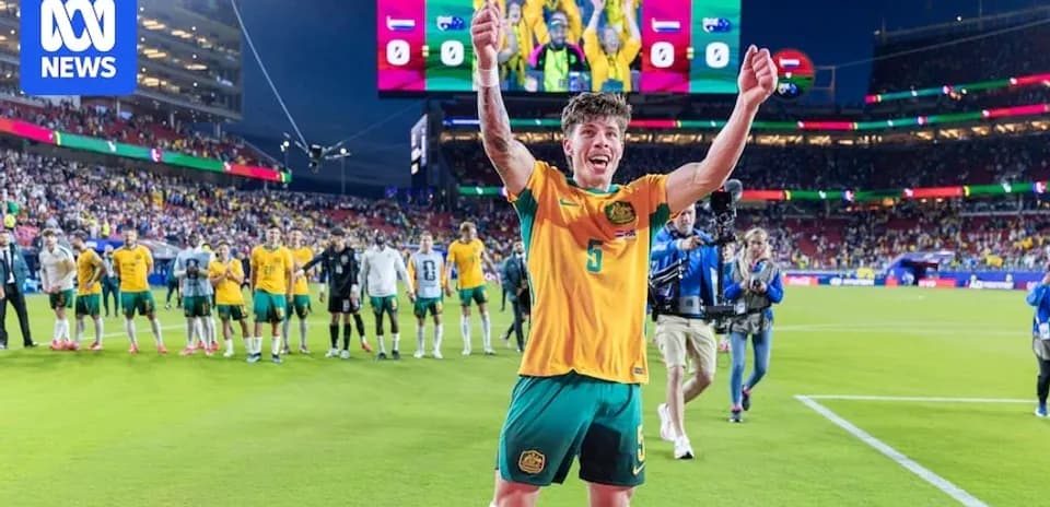 Player celebrating victory on the pitch with teammates