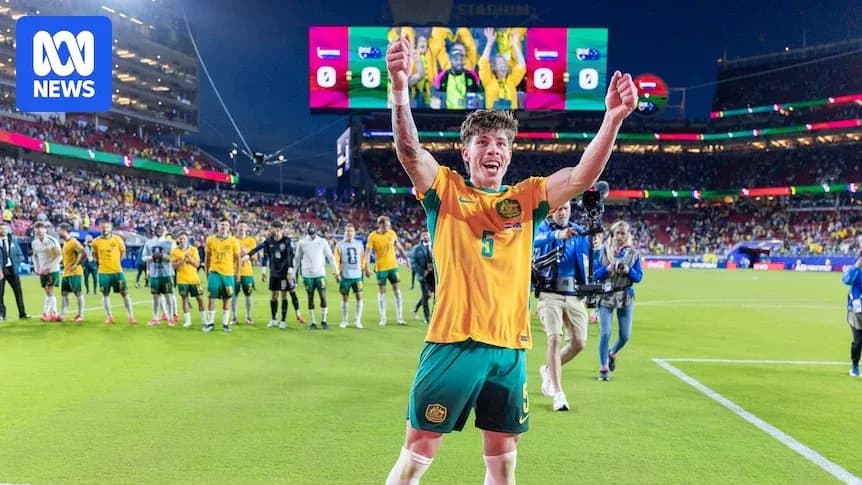 Player celebrating victory on the pitch with teammates