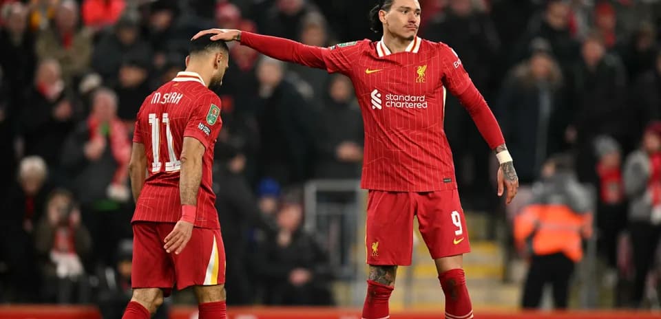 Liverpool players interacting on the pitch during match