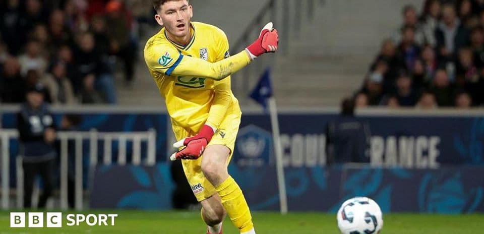 Goalkeeper in yellow kit making a pass