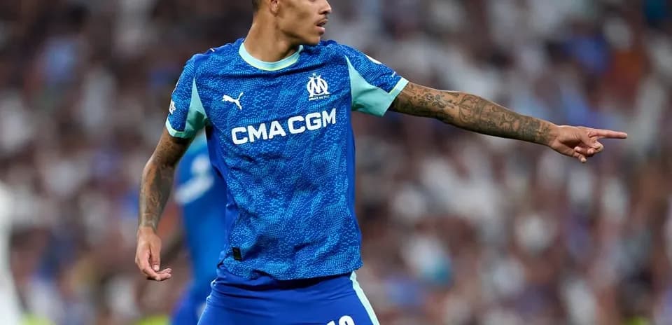 Player gesturing during a match wearing Marseille kit