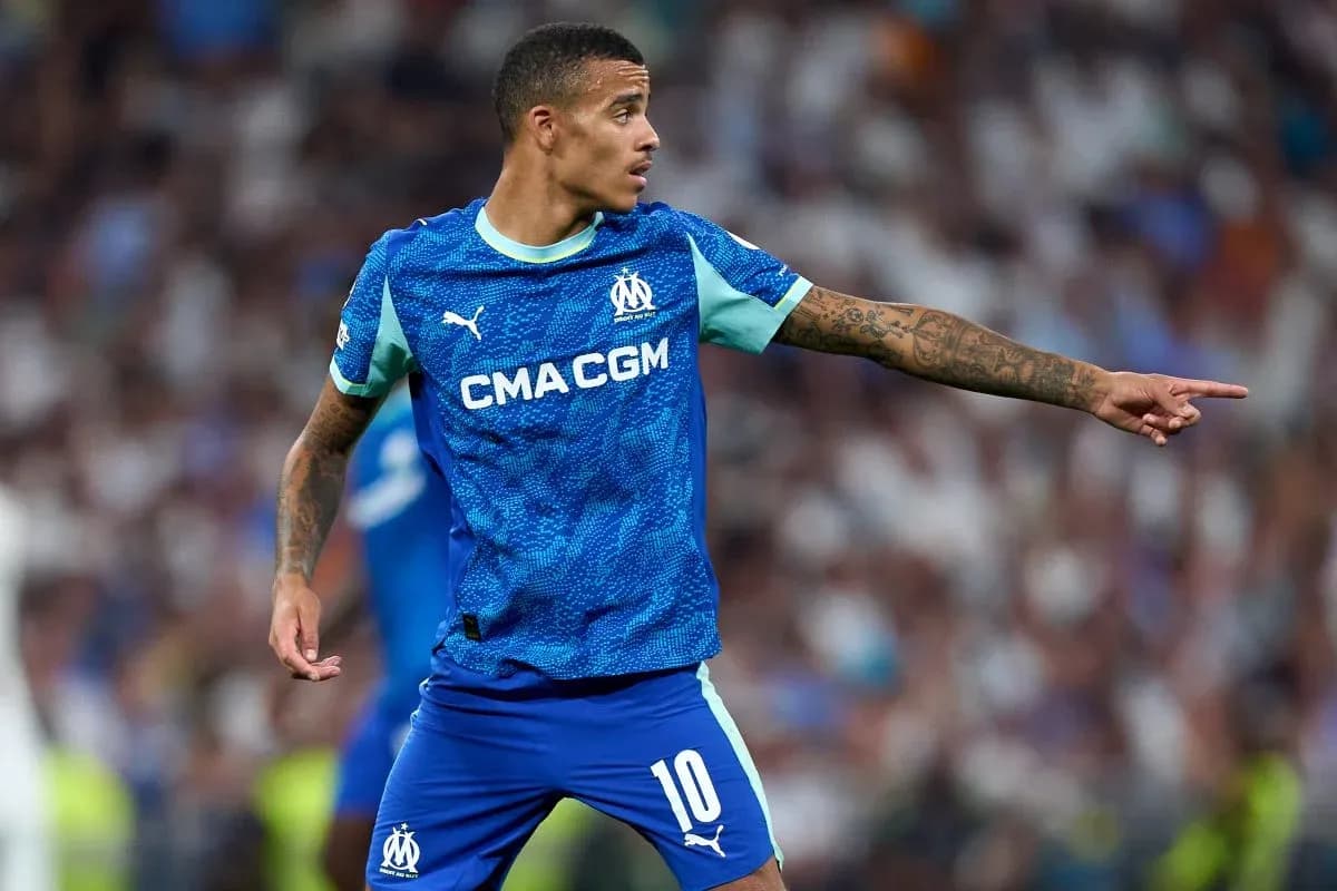 Player gesturing during a match wearing Marseille kit