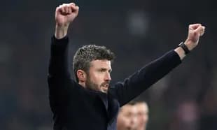 Manager celebrating with raised arms during match