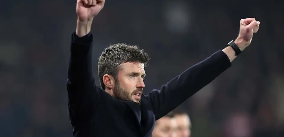 Manager celebrating with raised arms during match