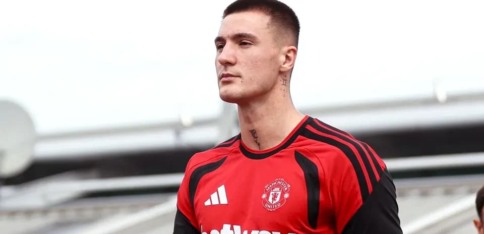 Player in Manchester United training kit on pitch