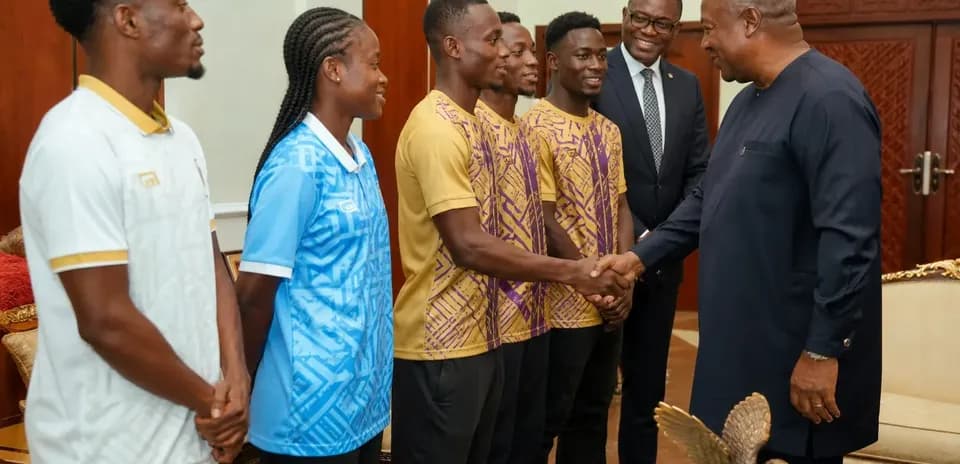 Athletes meeting with a government official indoors