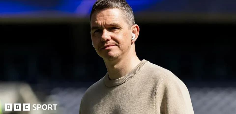 Man wearing earbuds standing on sports field