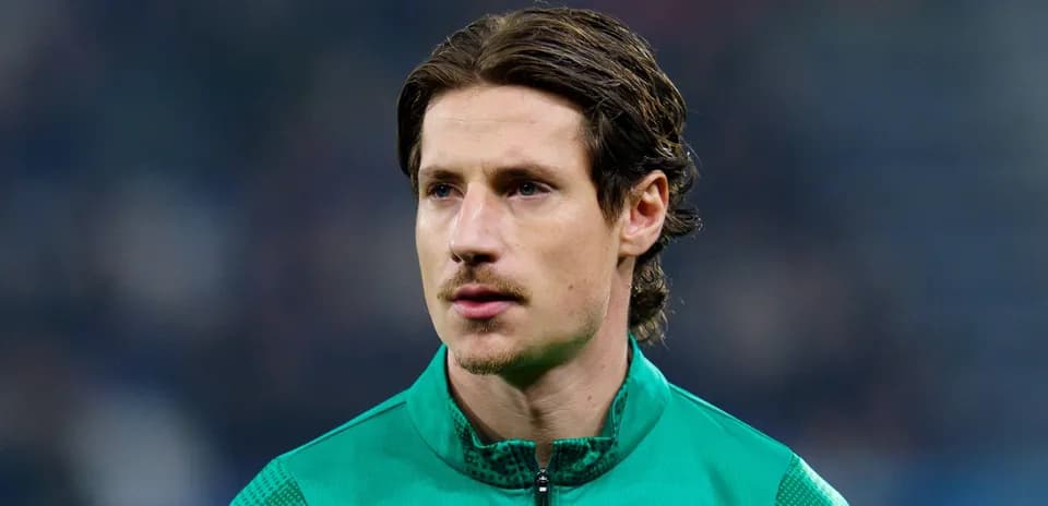 Goalkeeper in green kit during match warm-up