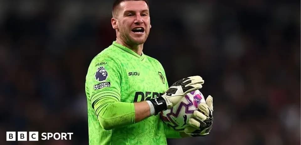 Goalkeeper in green kit holding a ball