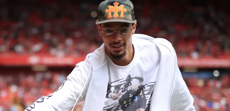 Player greeting fans in stadium before match