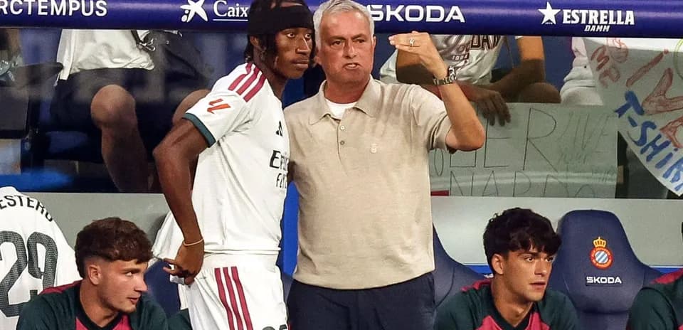 Manager discussing strategy with player on bench