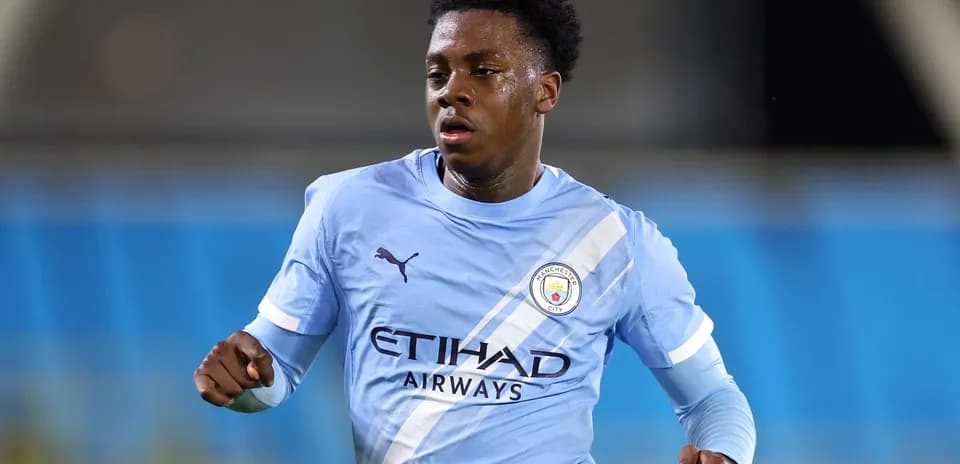 Player running in Manchester City home kit