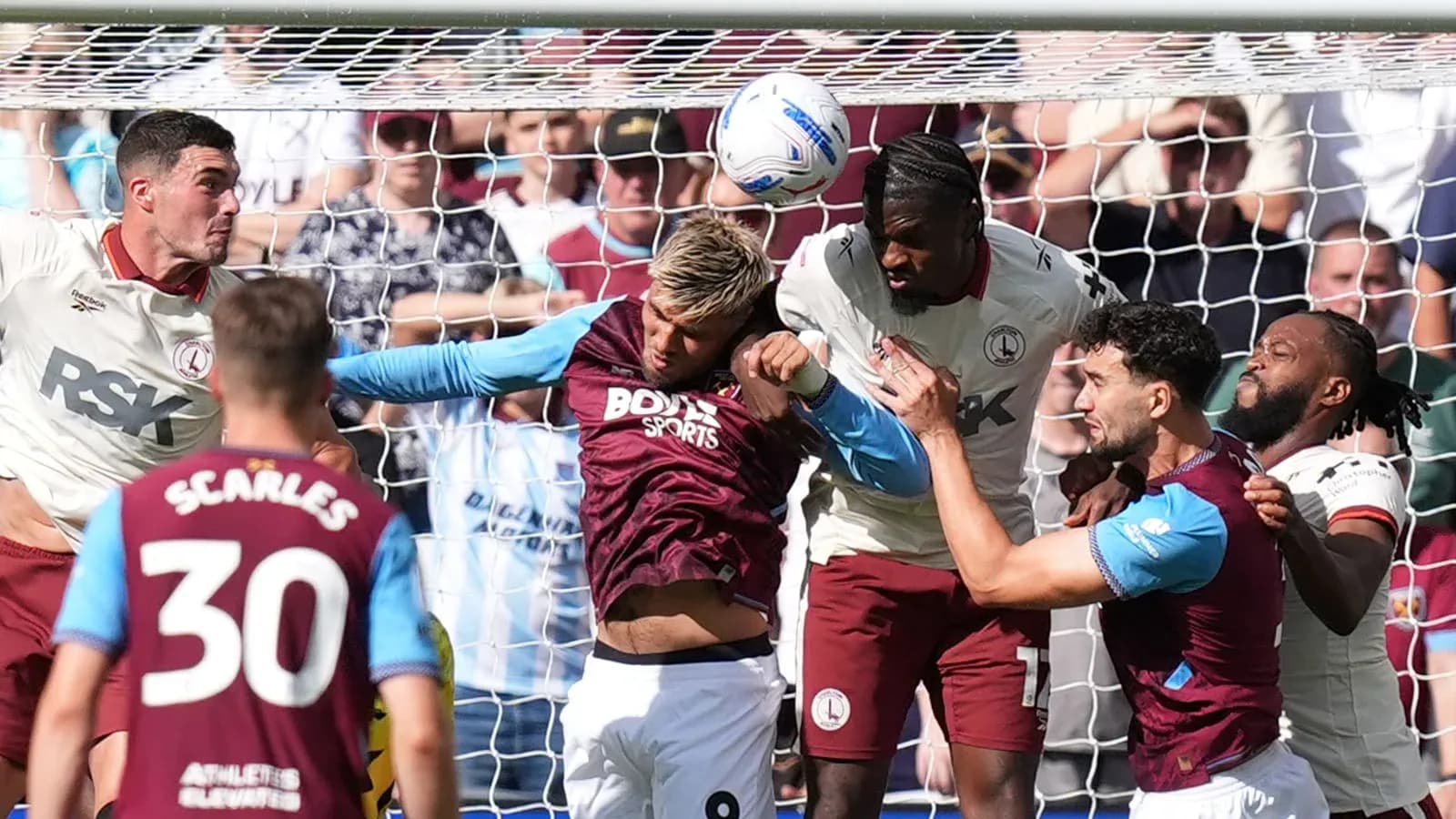 Players contesting a header in front of the goal
