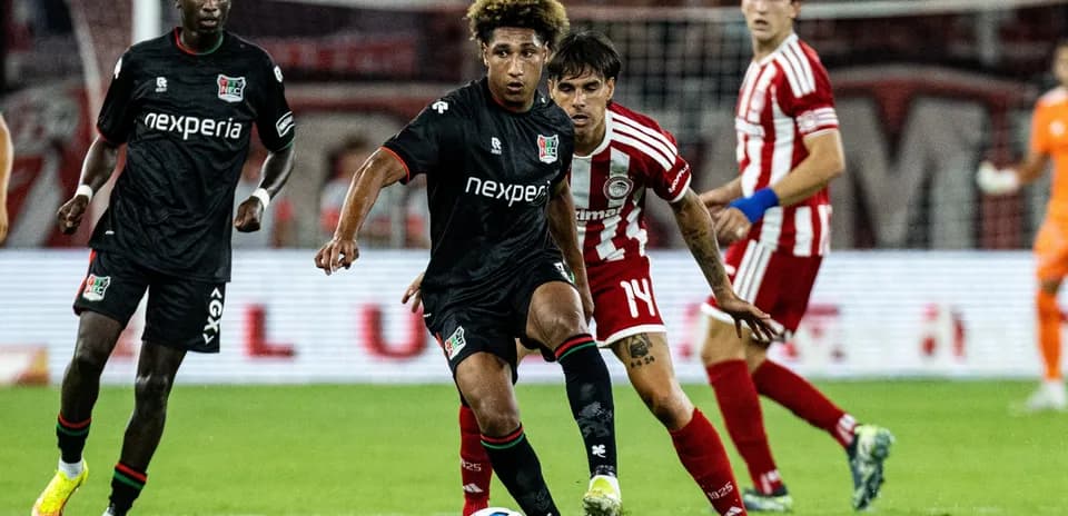 NEC player dribbling past Olympiakos defenders