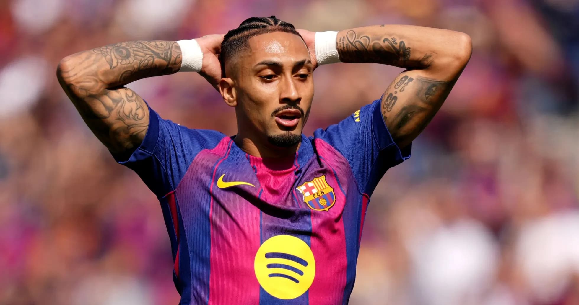 Player with arms raised in Barcelona jersey