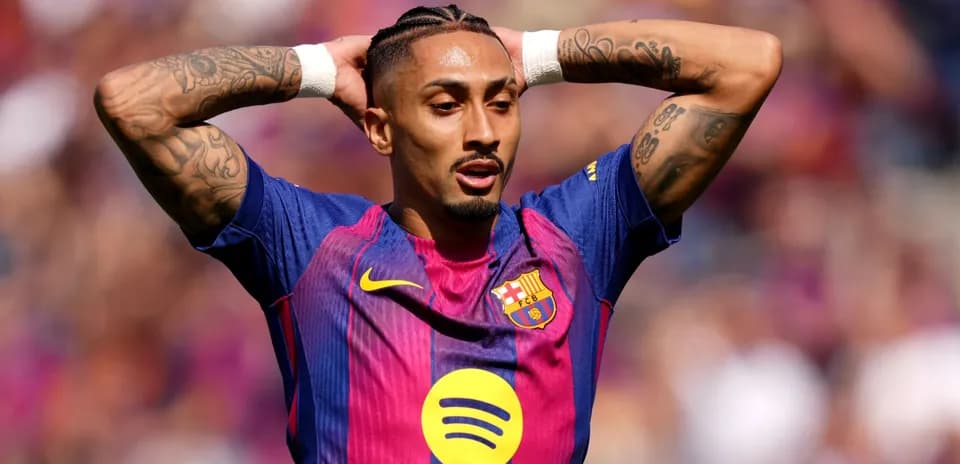 Player with arms raised in Barcelona jersey