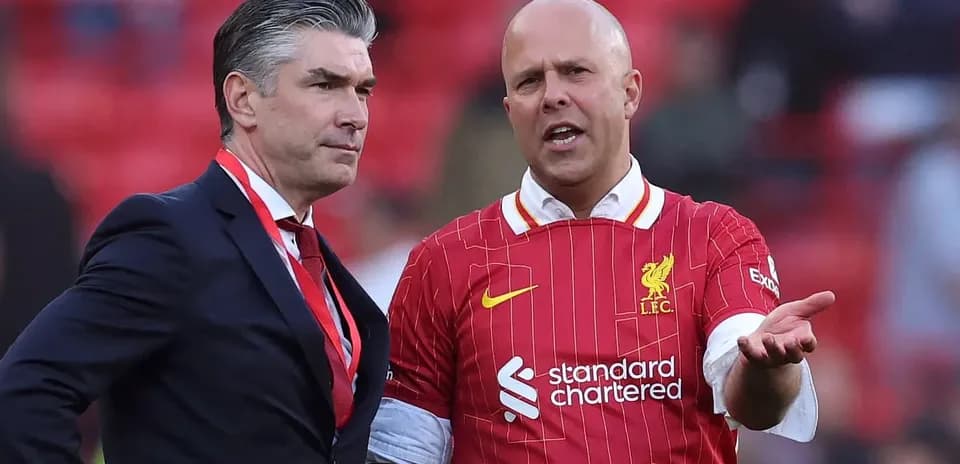 Two men discussing on the pitch at Anfield