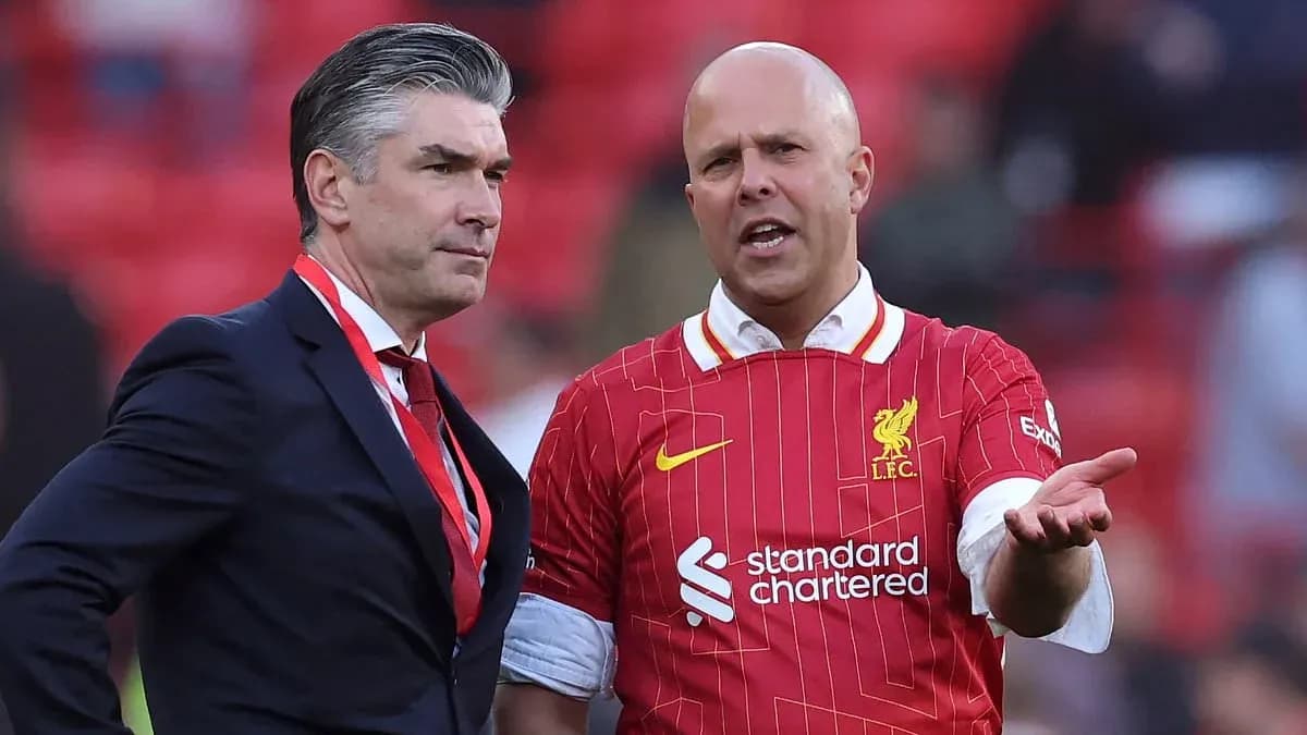 Two men discussing on the pitch at Anfield