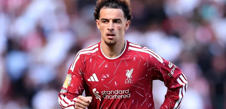 Player wearing Liverpool jersey during match action
