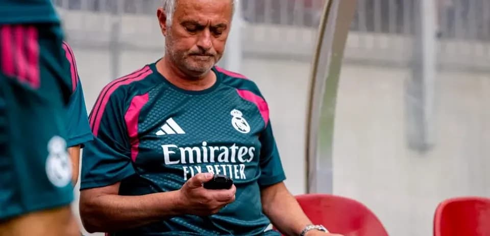 Manager sitting on bench using mobile phone