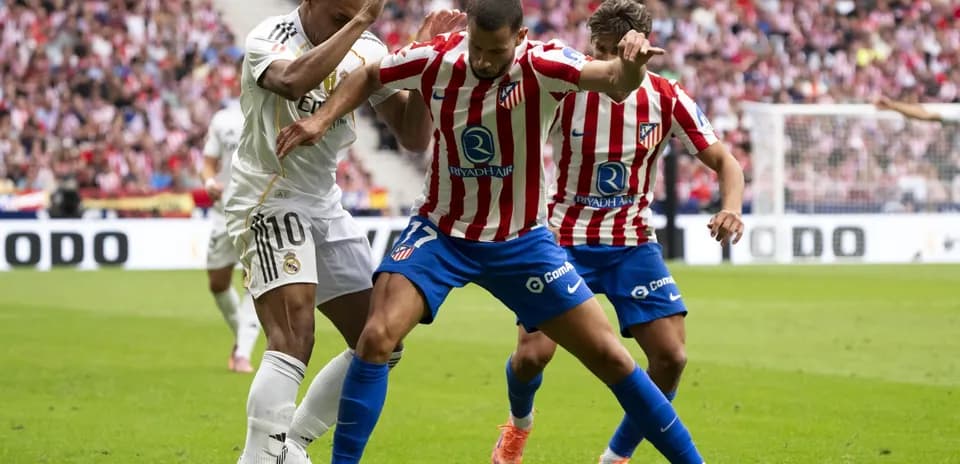 Real Madrid and Atletico Madrid players competing for the ball