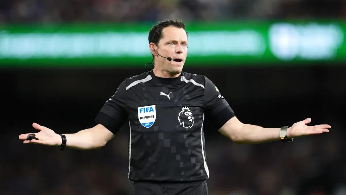 Referee gesturing during a football match