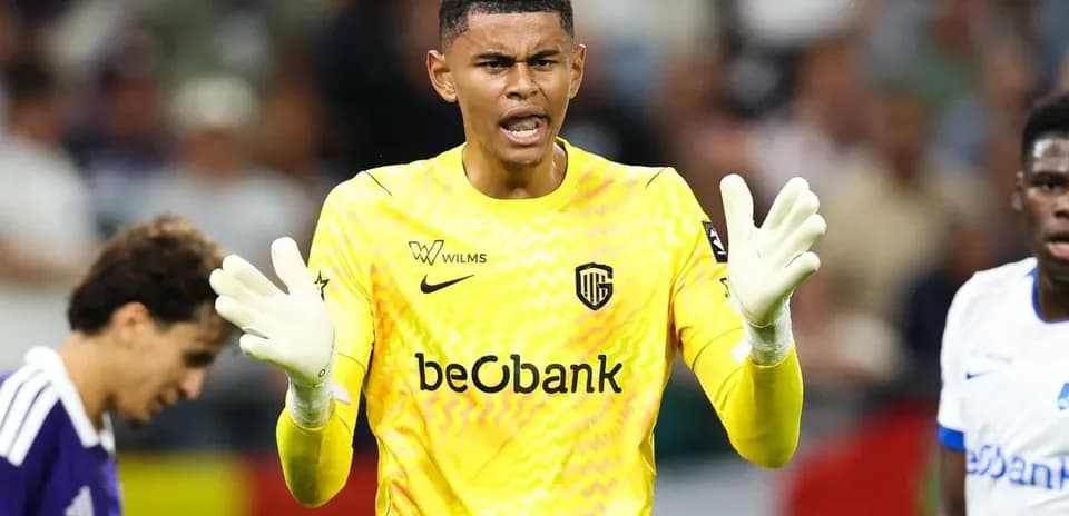 Goalkeeper in yellow jersey directing teammates during match