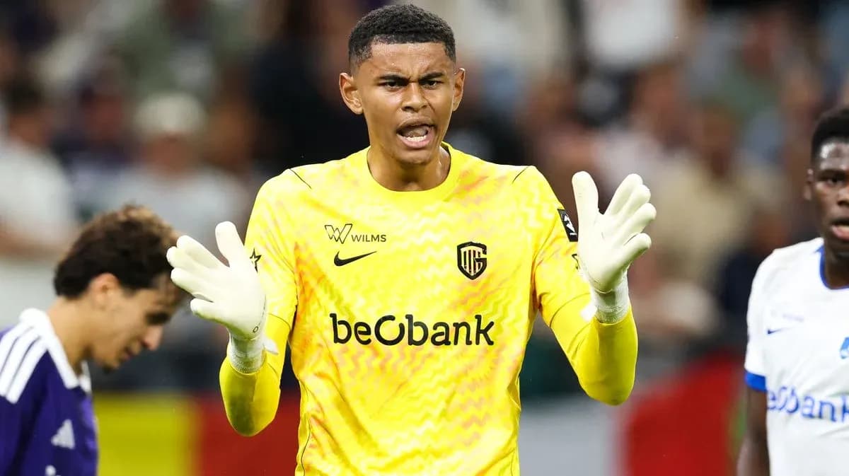 Goalkeeper in yellow jersey directing teammates during match