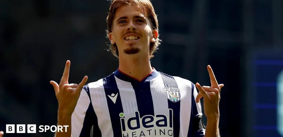 Player celebrating with hand gestures in team jersey
