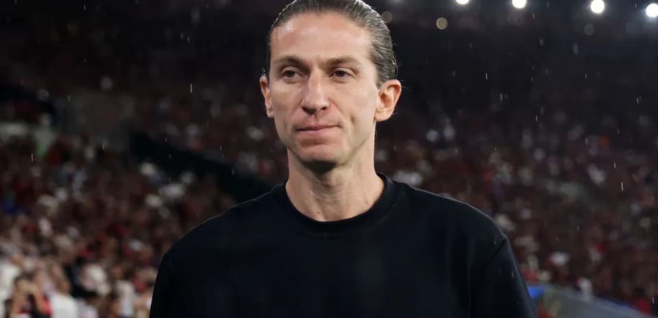 Coach on the field during a rainy match